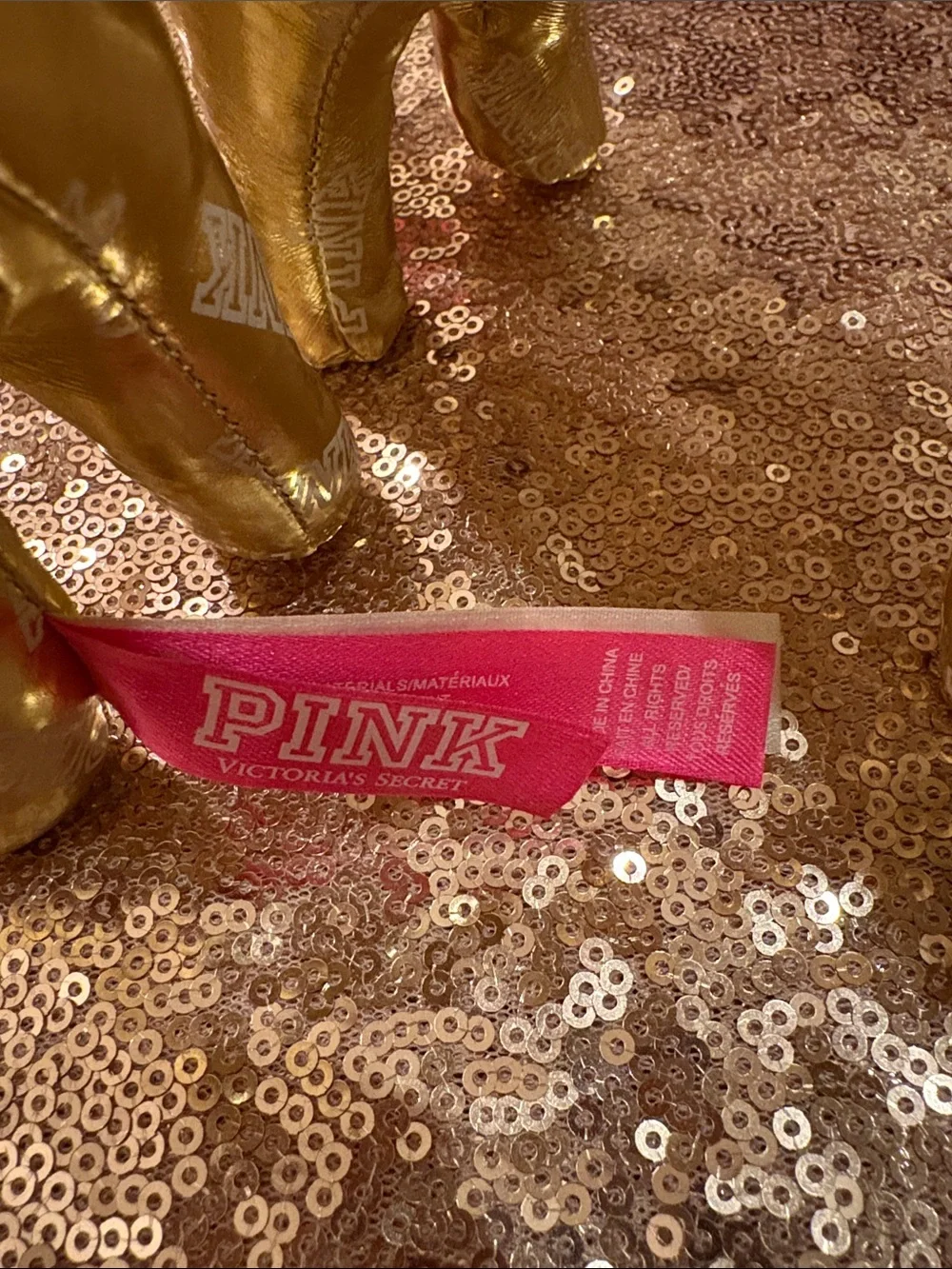 Lot of two 6” high x 10”  Victoria’s Secret gold metallic dogs w/allover logos